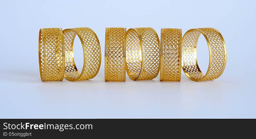 Golden napkin holders in the form of openwork rings