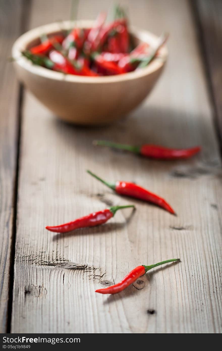 Red Hot Chili Peppers in bowl over wooden background. Red Hot Chili Peppers in bowl over wooden background