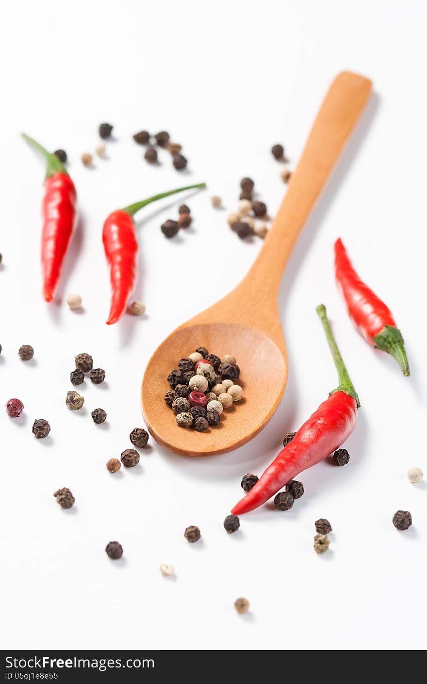 Mixed pepper in wooden spoon isolated on white background. Mixed pepper in wooden spoon isolated on white background