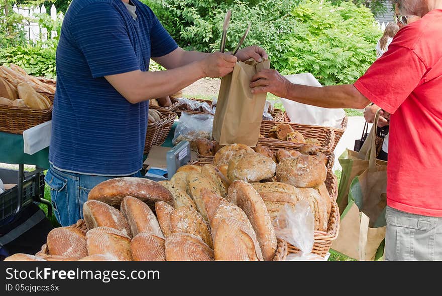 Sale of organic loaves at outdoor farmers market. Sale of organic loaves at outdoor farmers market