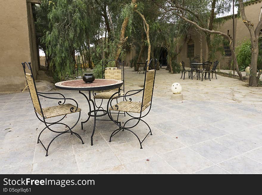 Patio with table and chairs in Hotel in Ouarzazate , Morocco.