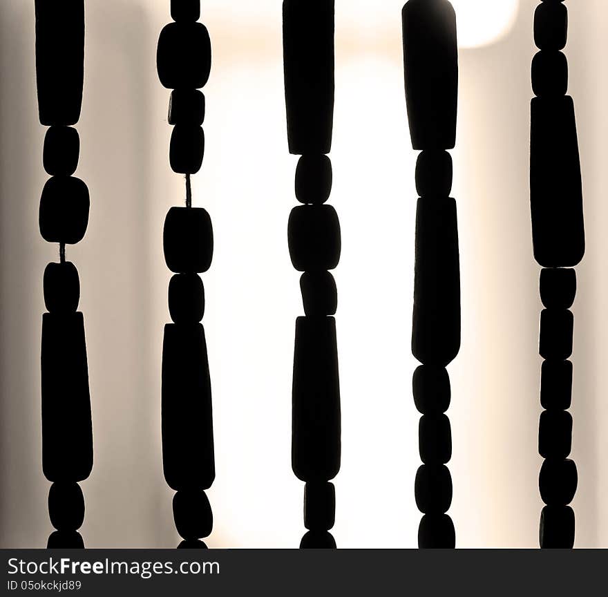 Closeup of wood beaded curtain silhouette. Closeup of wood beaded curtain silhouette