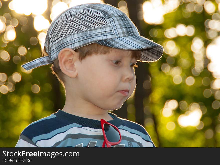 The little boy in a cap, looks aside