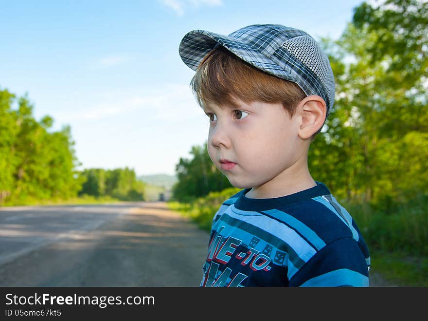 The little boy in a cap looks an amazed look