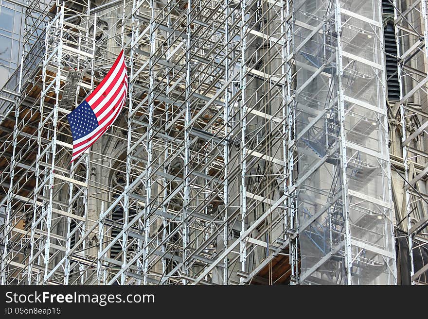 The flag is a great contrast to the grey scaffolding. The flag is a great contrast to the grey scaffolding