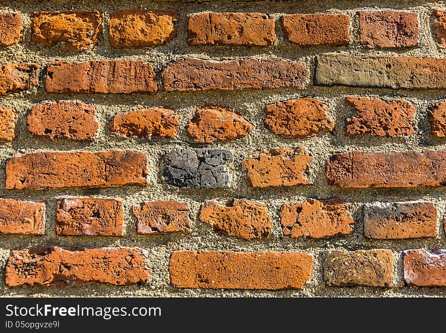 Closeup of the brick wall enlightened by the sun.