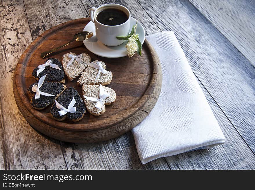 Cookies for the wedding with a cup of coffee served with a golden spoon. From the series Wedding Cookies. Cookies for the wedding with a cup of coffee served with a golden spoon. From the series Wedding Cookies