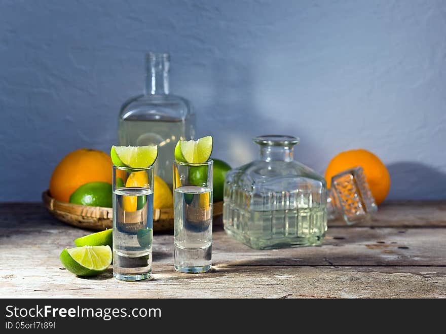 Tequila and citrus fruits on a old table