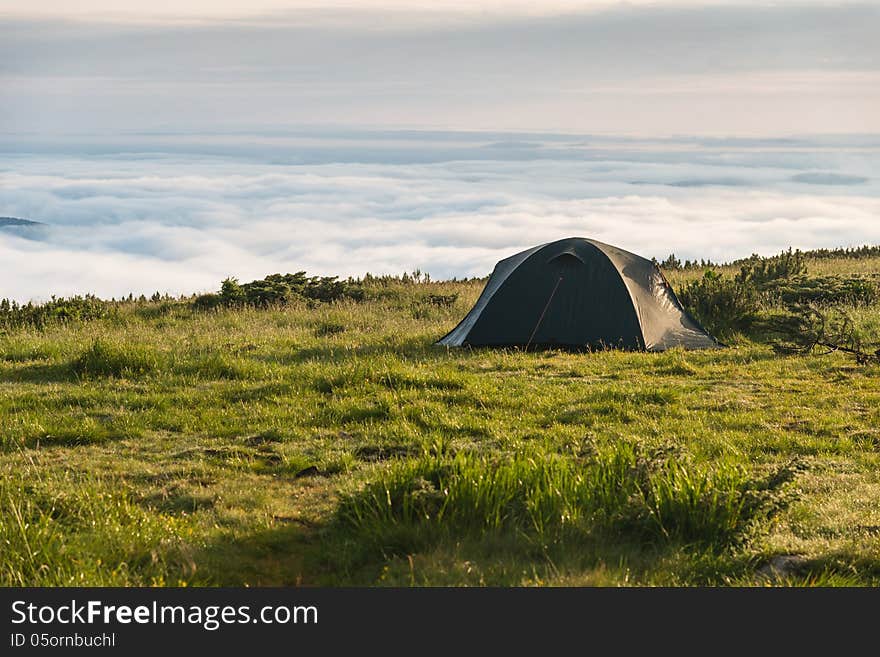 Tent in mountains above the clouds. Tent in mountains above the clouds