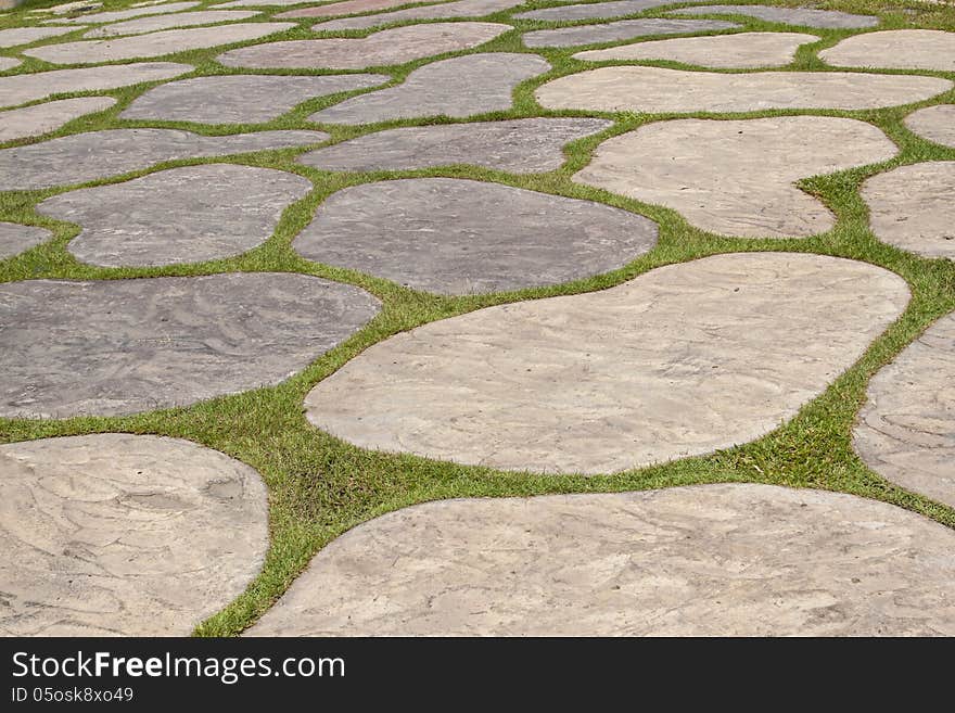 The pavement made of free form rock and grass. The pavement made of free form rock and grass