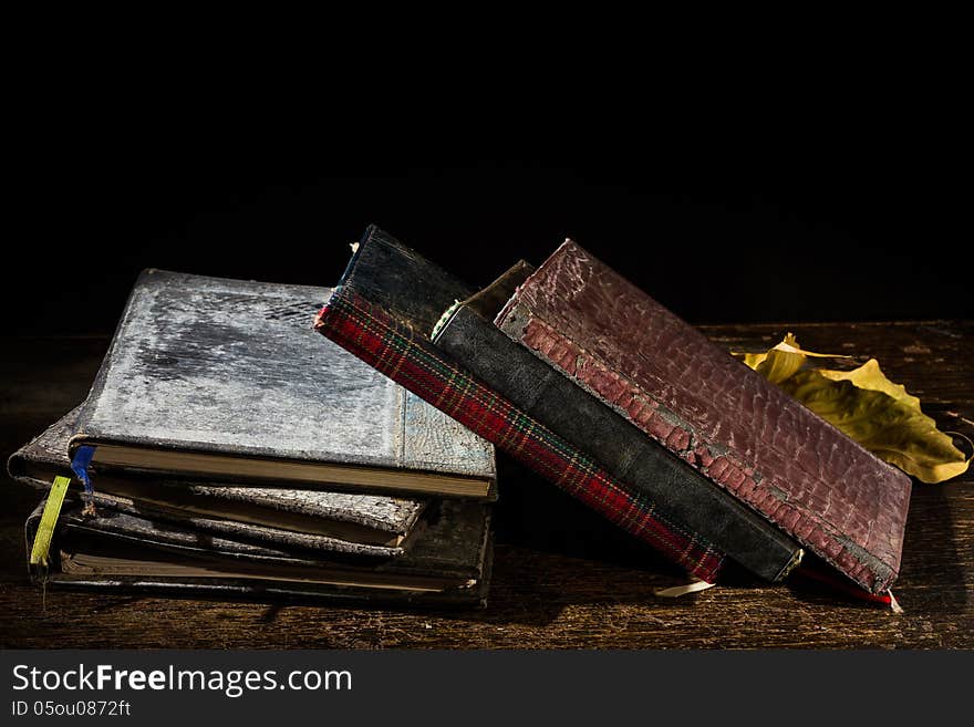 Pile of old notebooks on wooden table