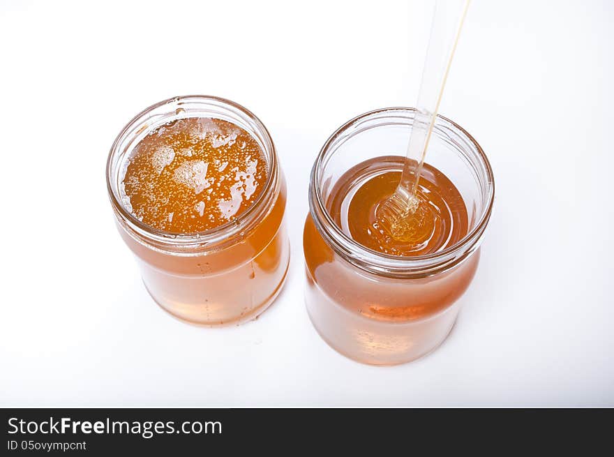 Two honey pots isolated on white background