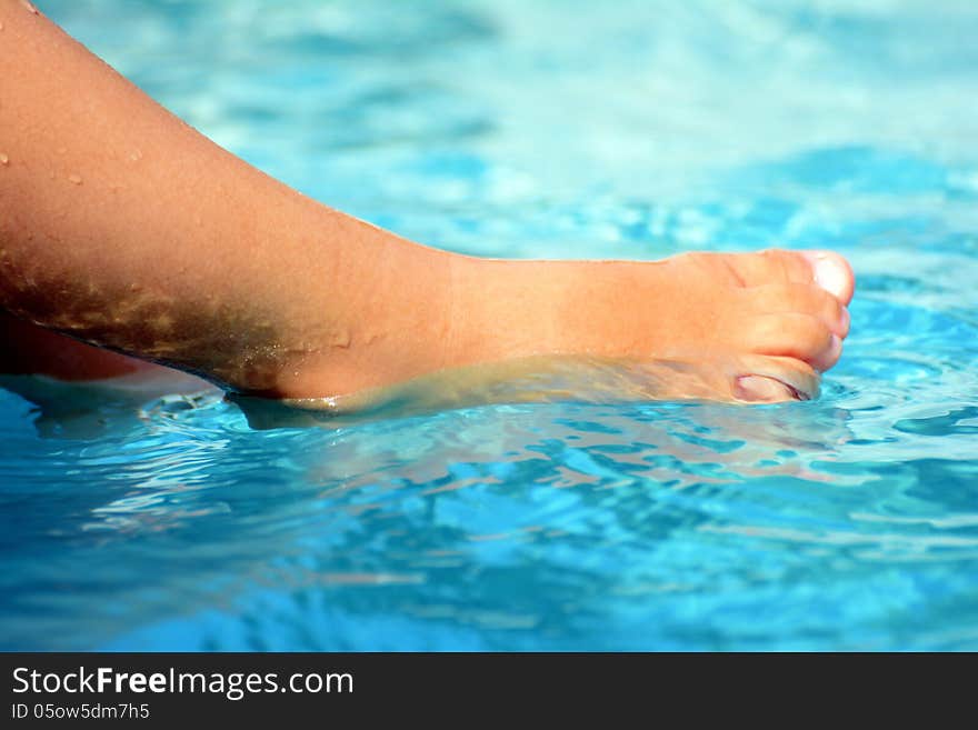 Boys playing at the pool splash with her feet