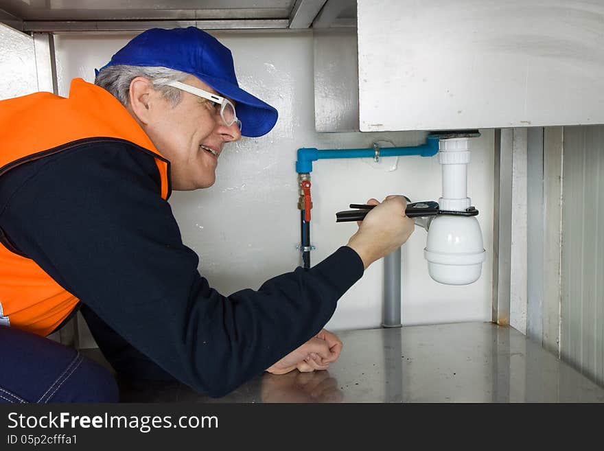 Plumber at work with an outdoor pipe plant