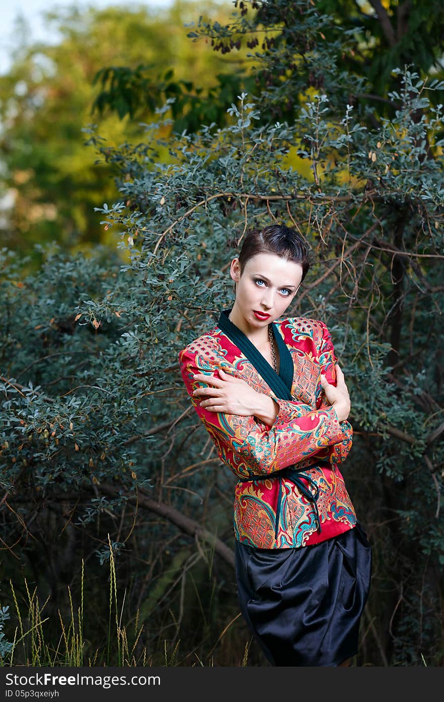 Young beautiful woman in a city park on a summer evening. Young beautiful woman in a city park on a summer evening