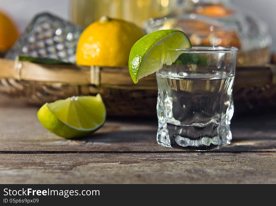 Tequila and citrus fruits on a old table. Tequila and citrus fruits on a old table