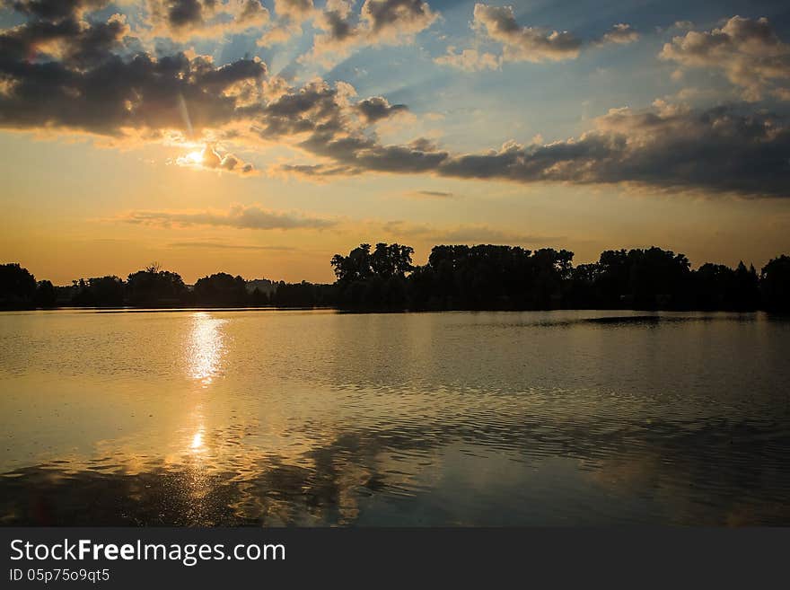 Sunrice behind lakes in the near forest