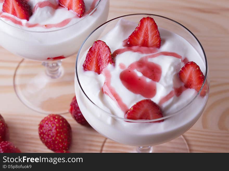 Strawberry yogurt on a wooden background