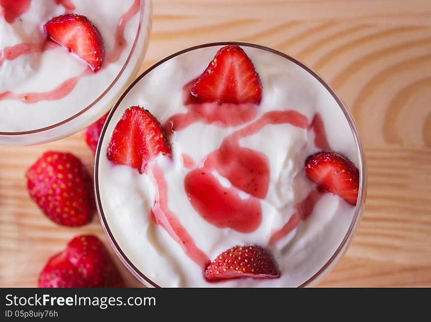 Strawberry yogurt on a wooden background