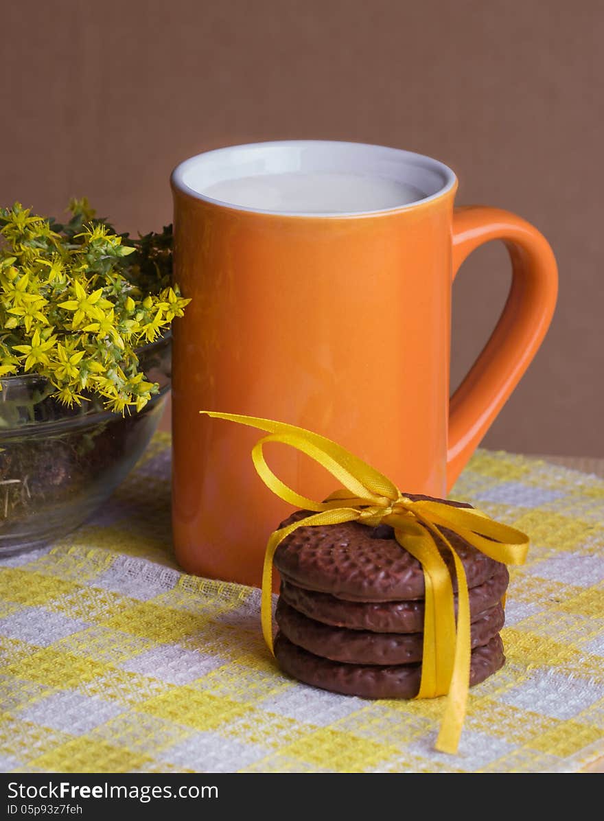 Chocolate cookies and milk and yellow flowers. Chocolate cookies and milk and yellow flowers