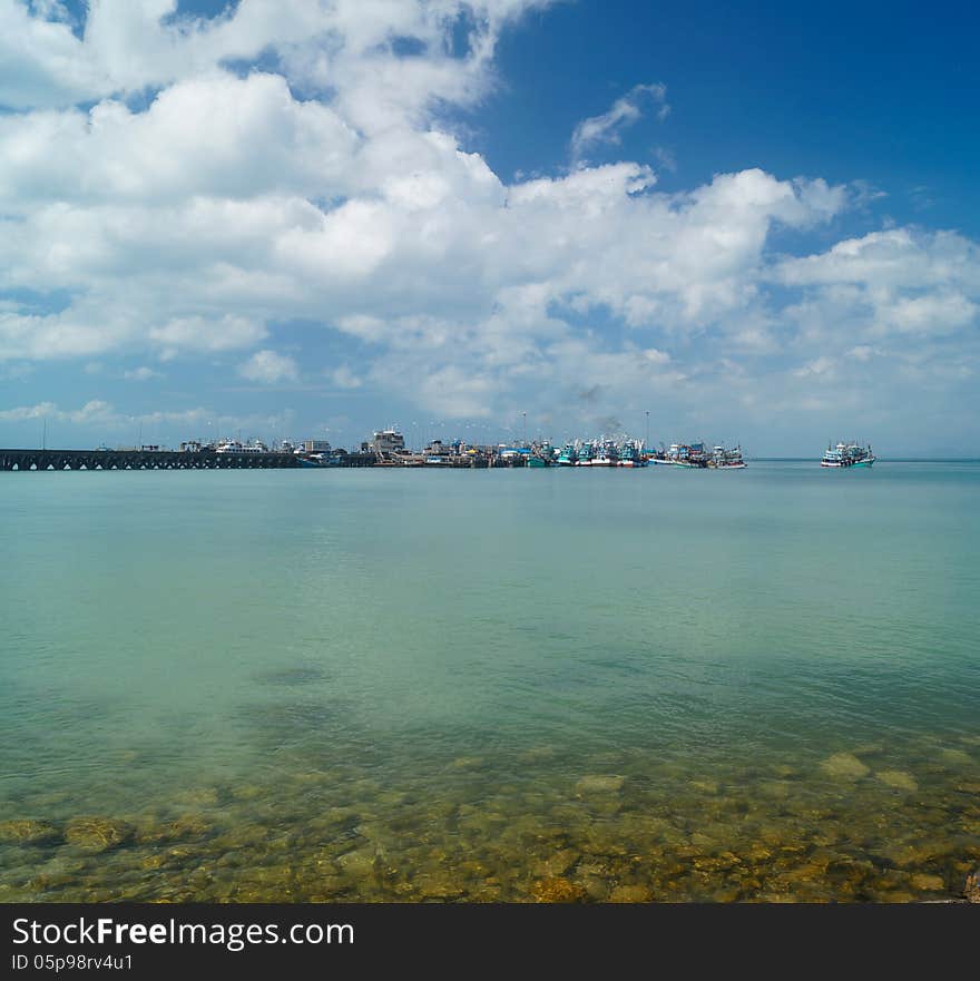 Pier with a cargo vessels оn a horizon