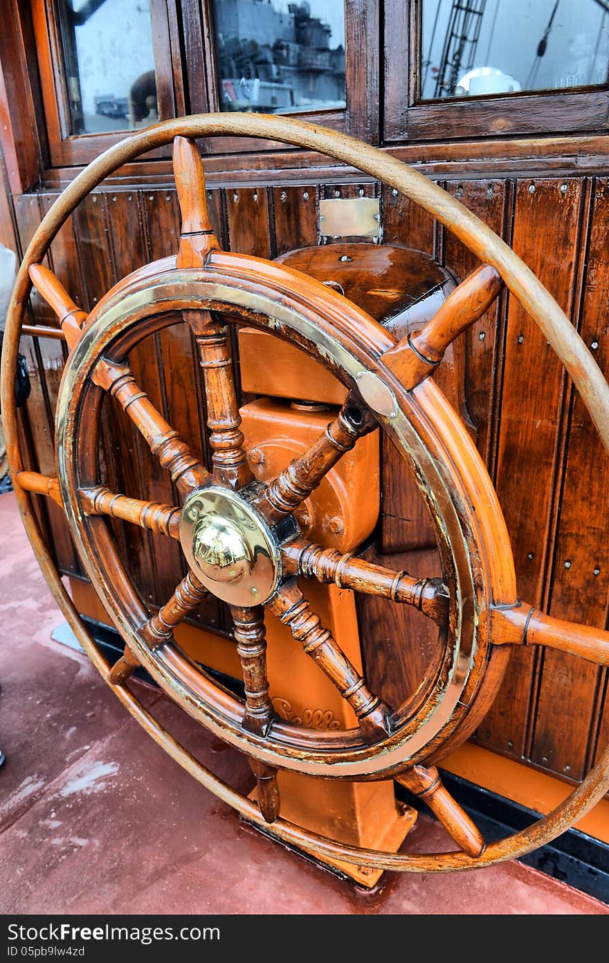 Steering wheel sailboat on old ship