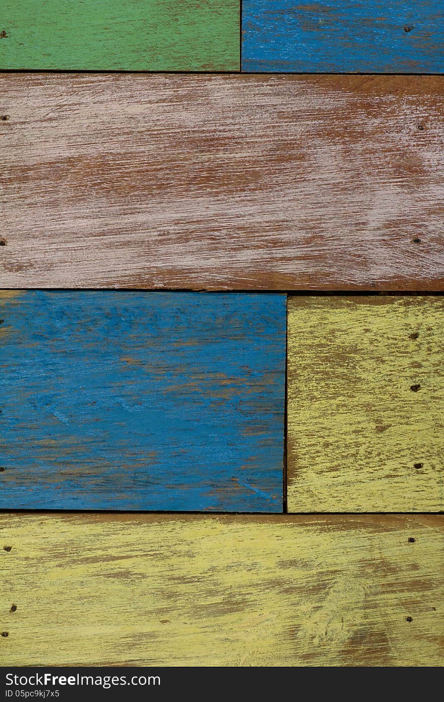 Detail of abstract art color wood wall yellow green blue