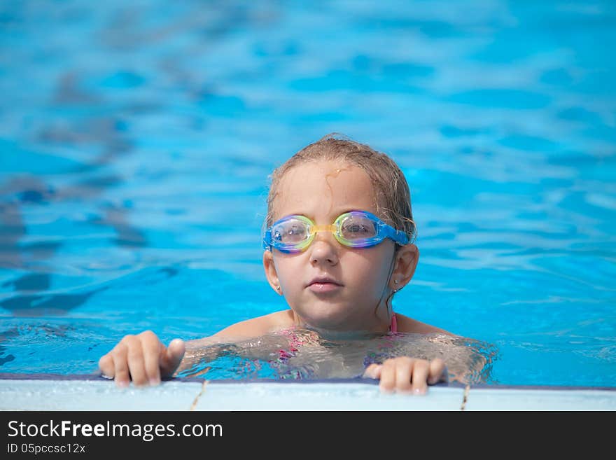 Girl swims in the pool