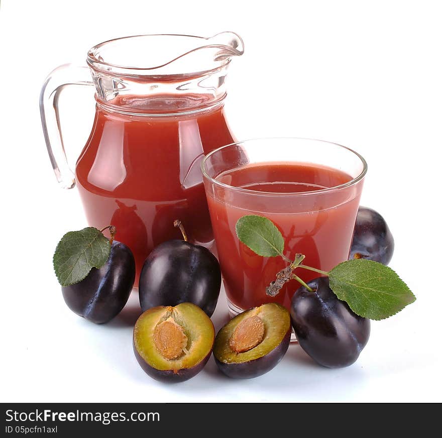 Plum juice in a jug and a glass of fruit. Plum juice in a jug and a glass of fruit