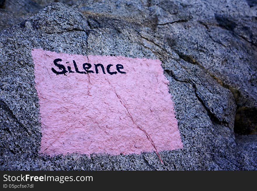 Silence sign on a high mountain wall near monastery. Silence sign on a high mountain wall near monastery.