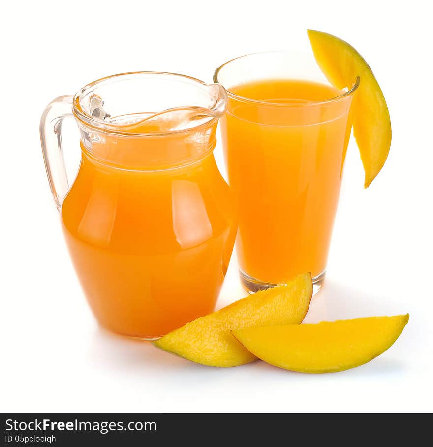 Mango juice in a jug and a glass of fruit. Mango juice in a jug and a glass of fruit