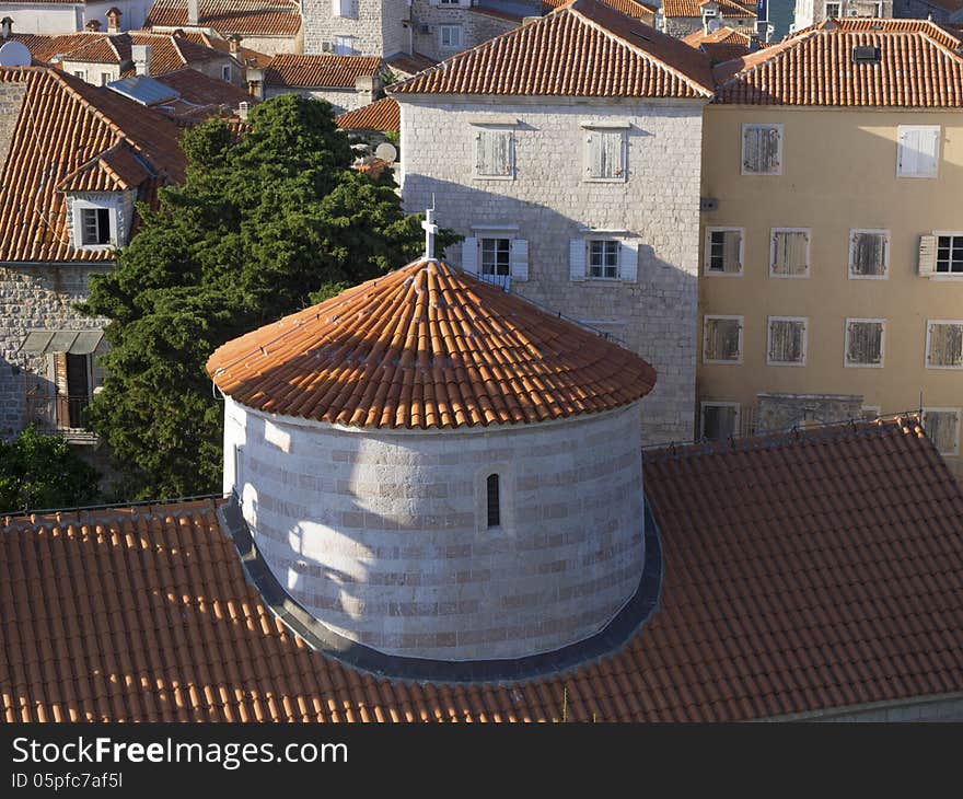 Top view to Budva old city with dome of St.John Cathedral on foreground