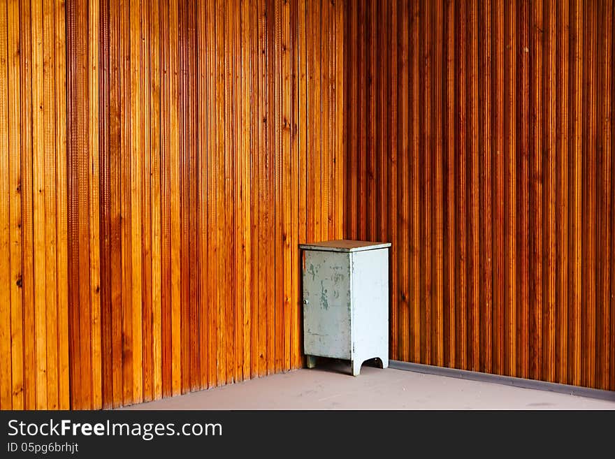 Bedside table in the corner on a panel natural wood background