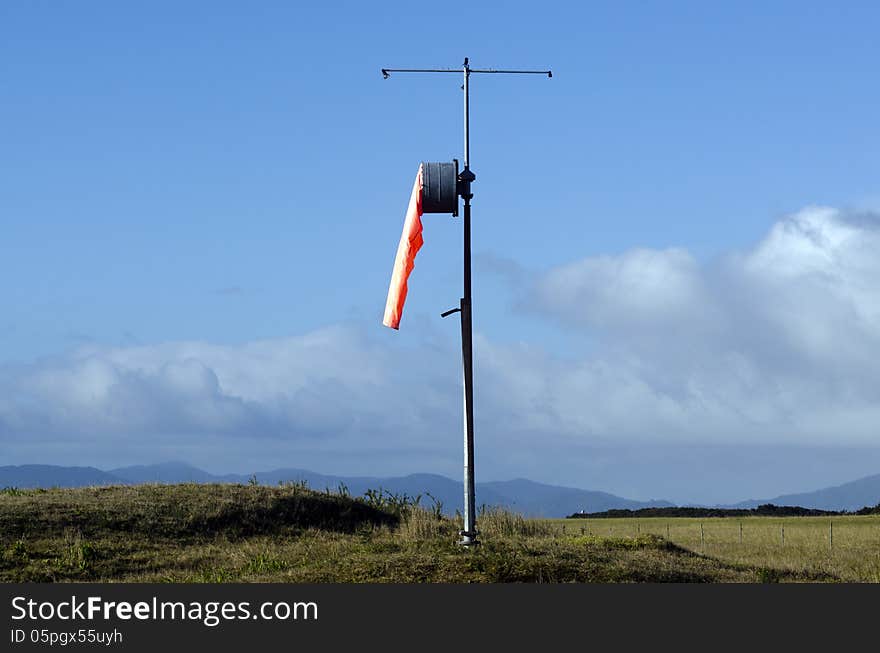 Airport windsock on a pole, show no wind.