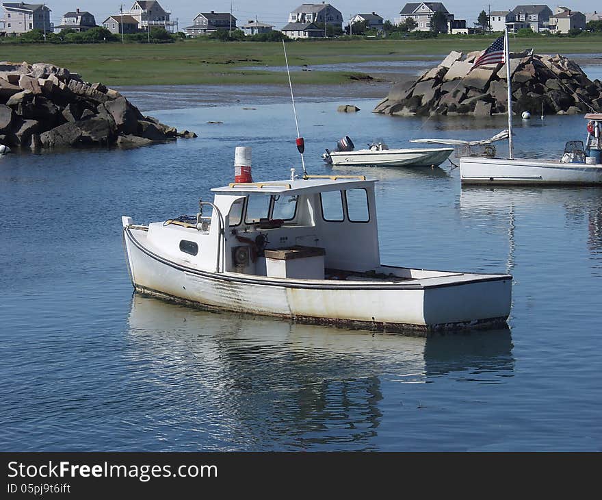 Maine lobster boats in harbor on clear summer day. Maine lobster boats in harbor on clear summer day.