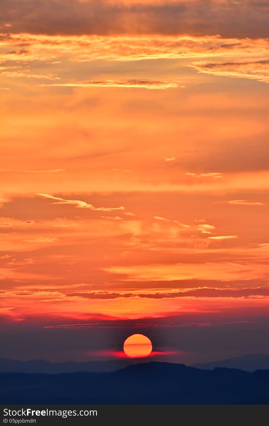 Orange sunset with purple reflections over the mountains.