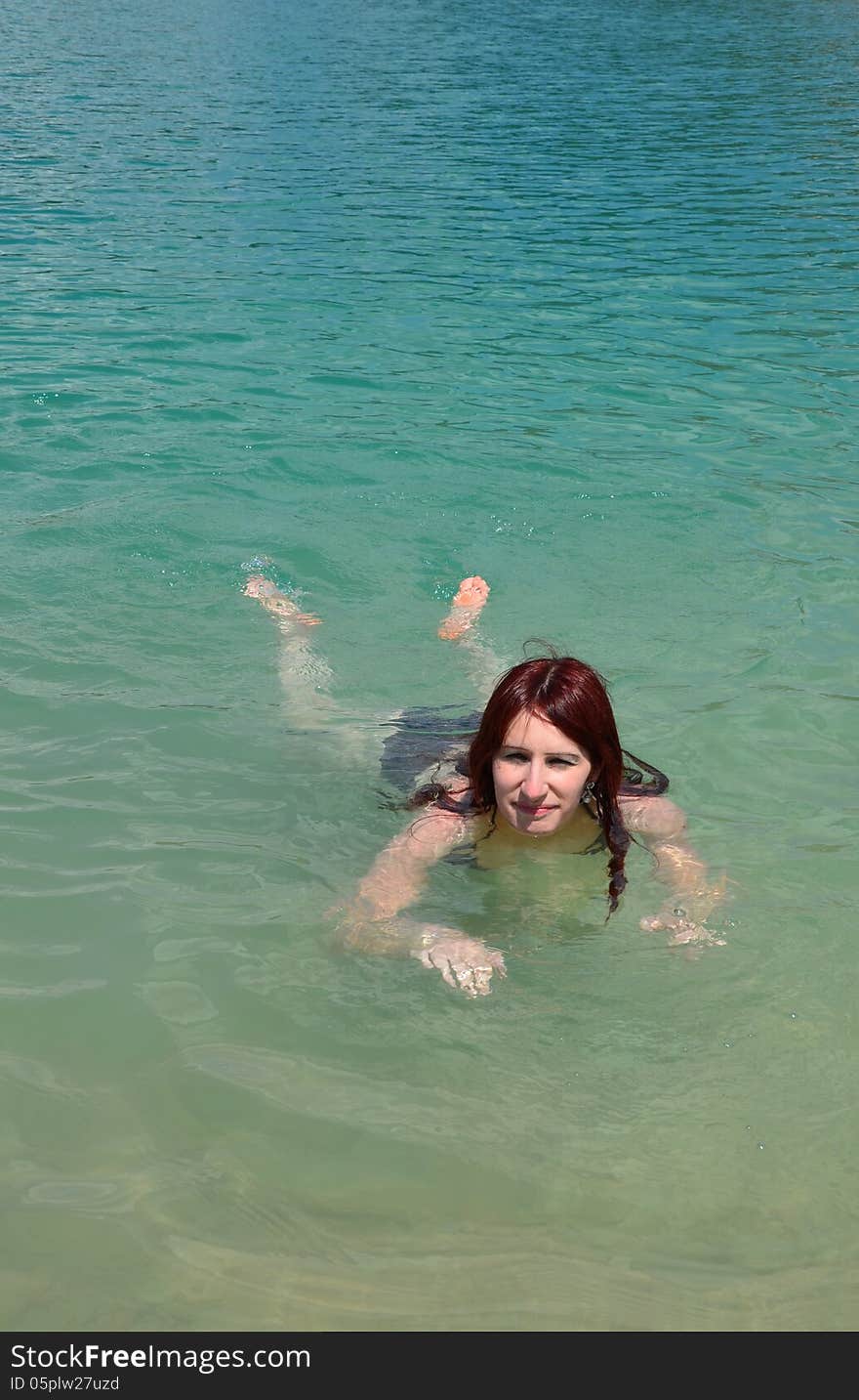 Young woman swimming in lake