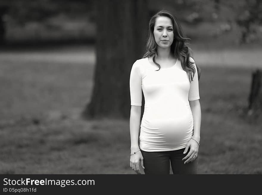 Pregnant woman standing in the park