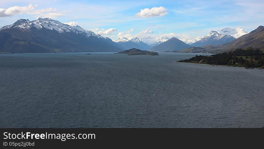 Spectacular snow-capped mountains rise on the banks of Lake Wakatipu in the famous Glenorchy region of New Zealand. Spectacular snow-capped mountains rise on the banks of Lake Wakatipu in the famous Glenorchy region of New Zealand.