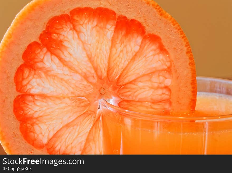 Glass of grapefruit juice with a slice of grapefruit