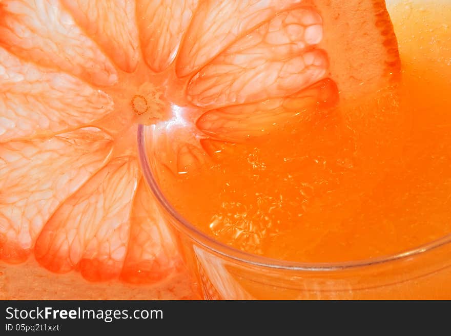 Glass of grapefruit juice with a slice of grapefruit