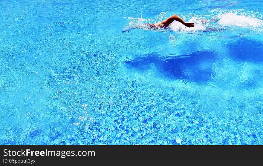 Sports and Activities. A man swims in the pool.