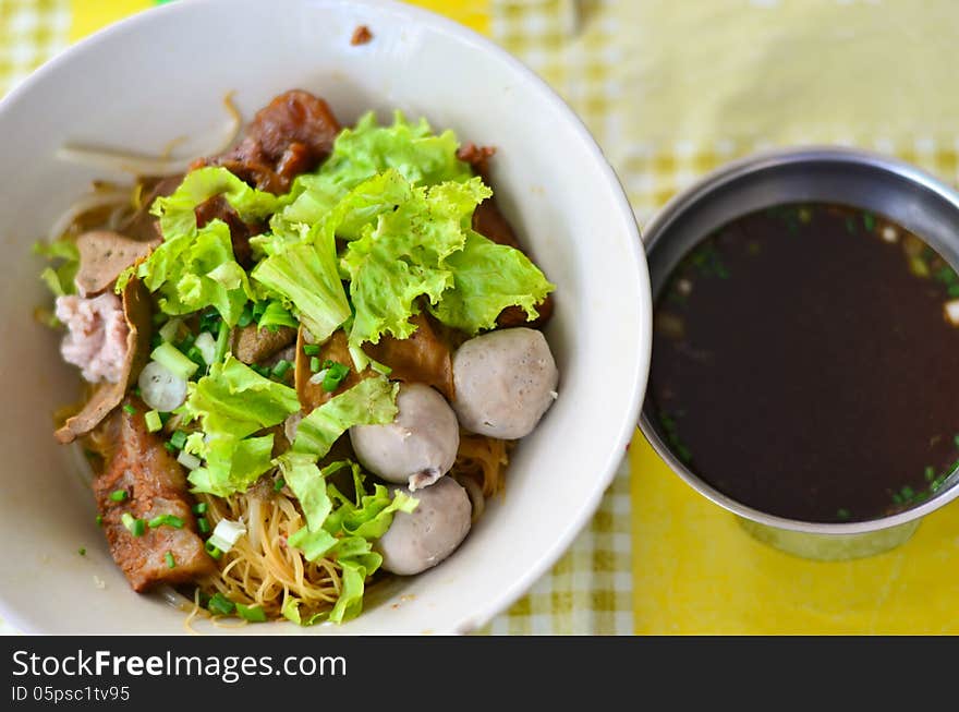 A bowl of noodle with a bowl of soup. A bowl of noodle with a bowl of soup.