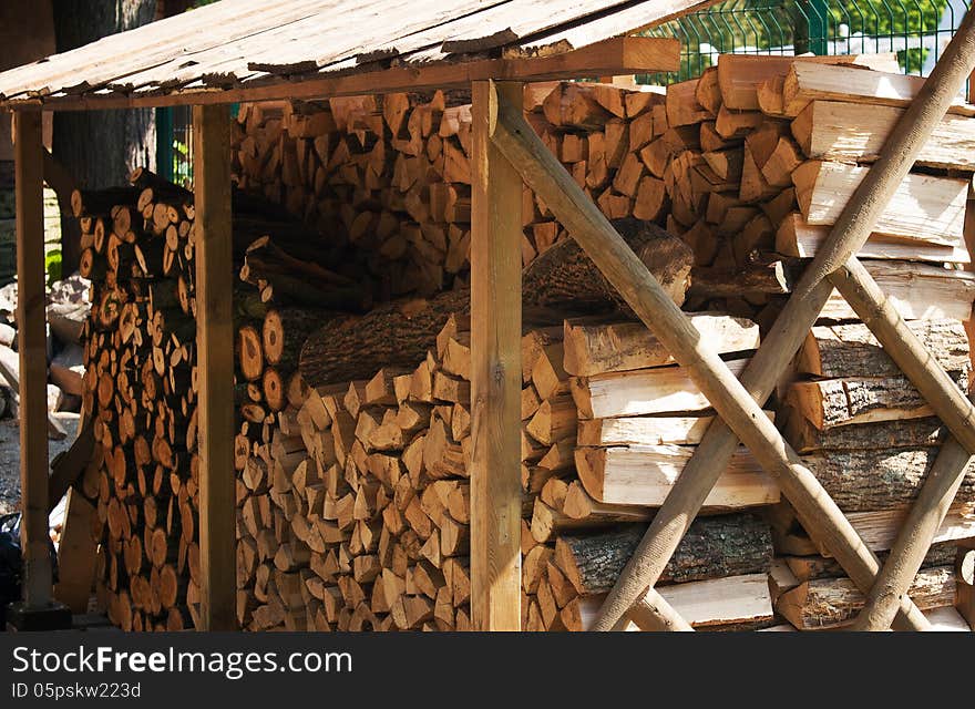 Stack of wood under cover on summer day