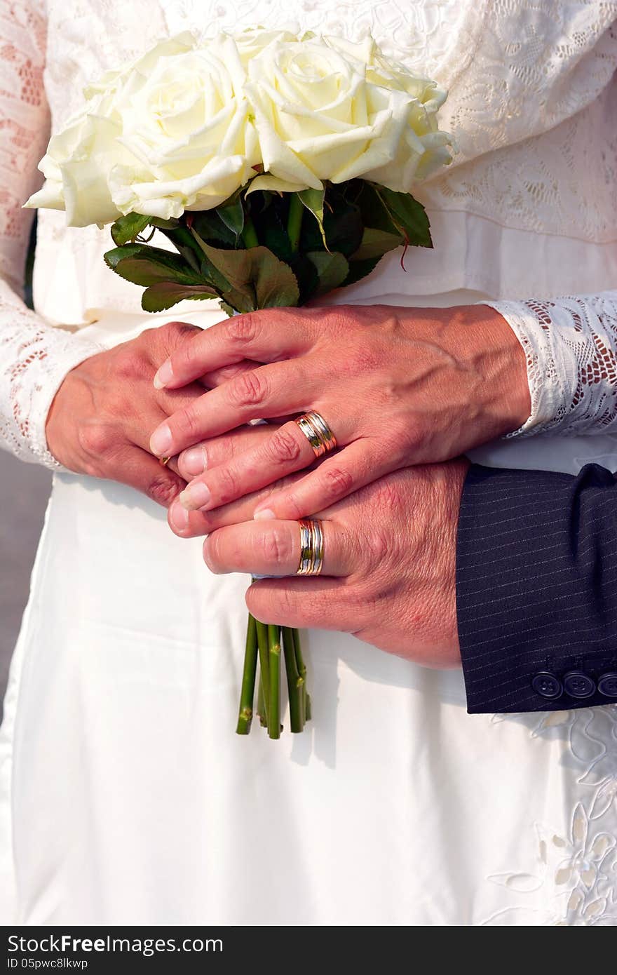 Bride and groom holding wedding flower bouquet