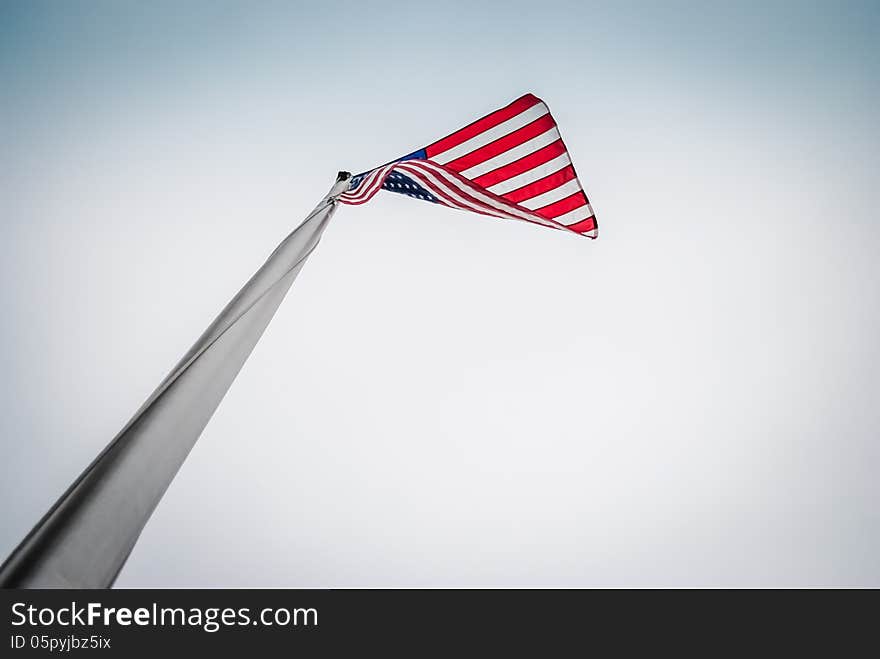 Looking up at a US flag flying. Looking up at a US flag flying