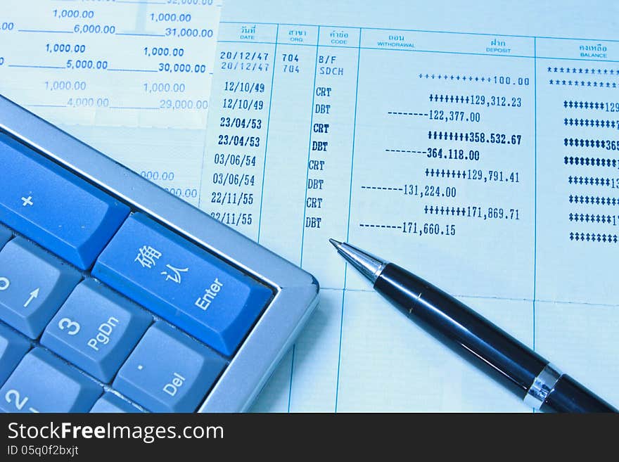 Accounting Calculator, pen and Bank account on table