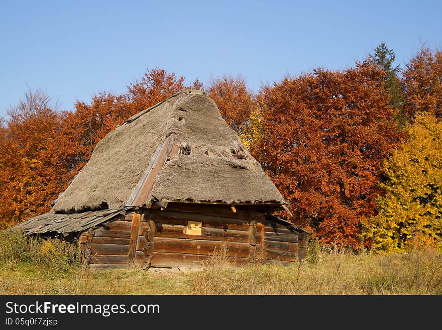 Old house with a thatched roof in autumn