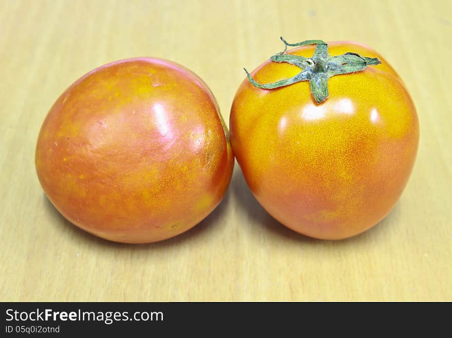 Tomatos on wood table background