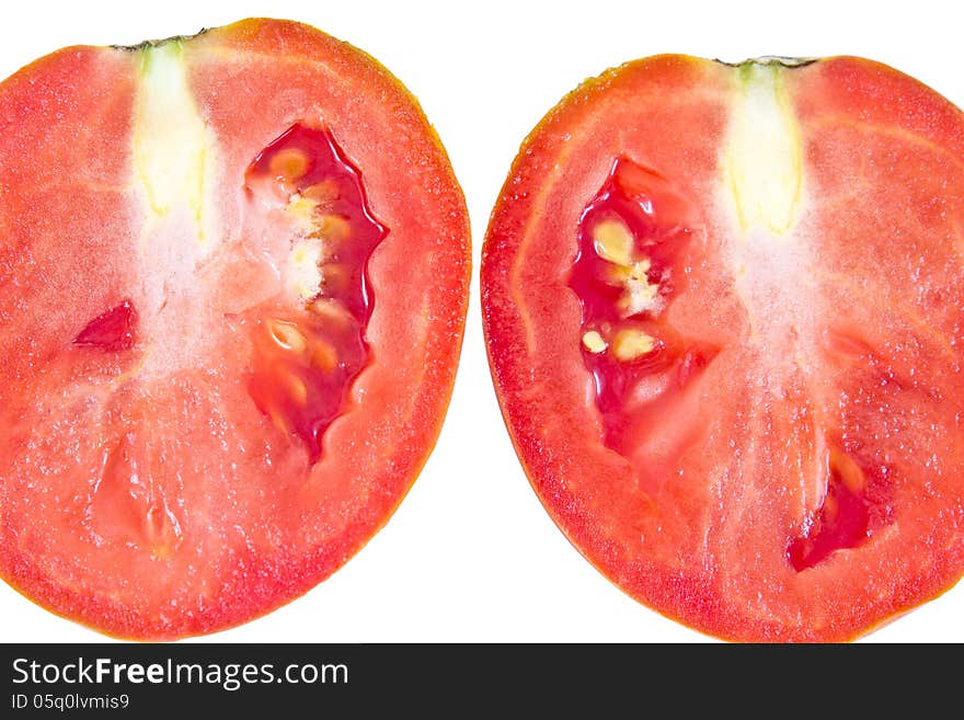 Cut of juicy tomato on a white background